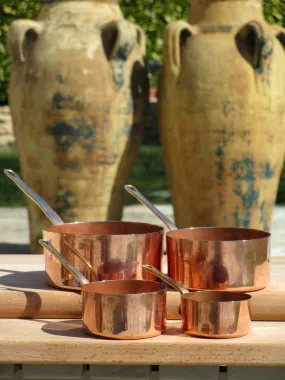 Set of four chef's copper saucepans